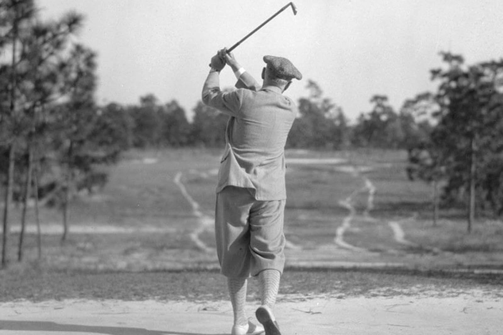 man mid swing of a golf club